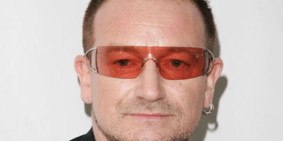 Amy Poehler kisses Bono at the...
