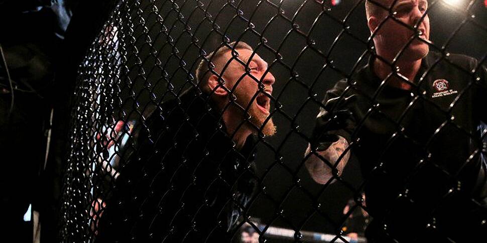 Conor McGregor Jumps Cage To C...