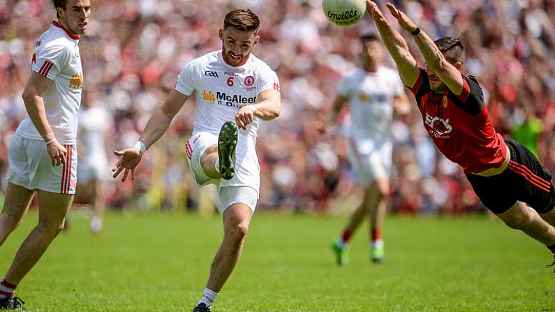 16 July 2017; Padraig Hampsey of Tyrone beats the attempted block of Niall McParland of Down during the Ulster GAA Football Senior Championship Final match between Tyrone and Down at St Tiernach's Park in Clones, Co. Monaghan. Photo by Oliver McVeigh/Sportsfile