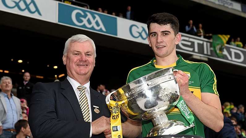 20 September 2015; Kerry captain Mark OConnor is presented with the cup by Uachtaran Chumann Luthchleas Gael Aogan O Fearghail. Electric Ireland GAA Football All-Ireland Minor Championship Final, Kerry v Tipperary, Croke Park, Dublin. Picture credit: Ray McManus / SPORTSFILE