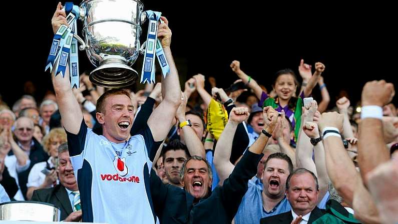 7 July 2013; Dublin captain John McCaffrey lifts the Bob O'Keeffe Cup at the end of the game watched on by former Dublin manager Humphrey Kelleher. Leinster GAA Hurling Senior Championship Final, Galway v Dublin, Croke Park, Dublin. Picture credit: David Maher / SPORTSFILE