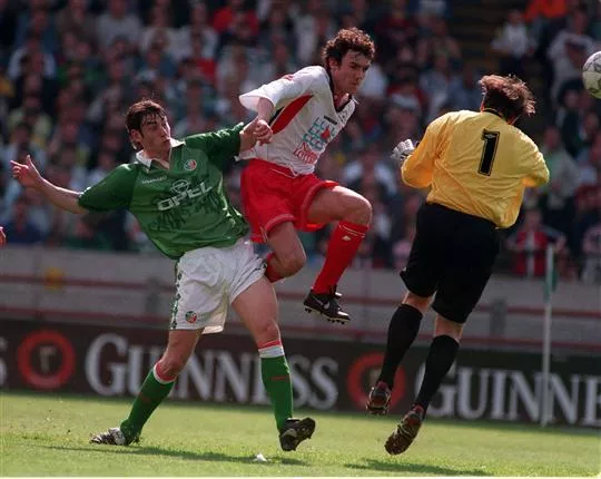 Christian Dailly and Rory Delap look on as Mark Bosnich collects the ball.