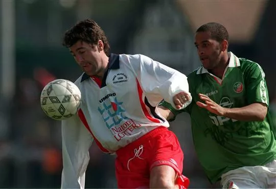 Dean Saunders and Phil Babb in action. This game was packed with stars.
