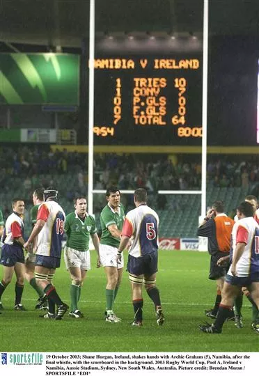 19 October 2003; Shane Horgan, Ireland, shakes hands with Archie Graham (5), Namibia, after the final whistle, with the scoreboard in the background. 2003 Rugby World Cup, Pool A, Ireland v Namibia, Aussie Stadium, Sydney, New South Wales, Australia. Picture credit; Brendan Moran / SPORTSFILE *EDI*