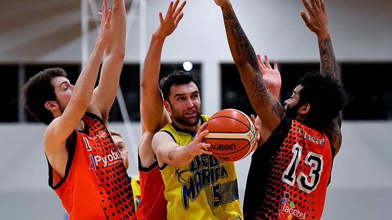 6 January 2018; Conor Meany of UCD Marian in action against Luis Filiberto Garcia Hoyos, left, and Royce Williams of Pyrobel Killester during the Hula Hoops Mens Pat Duffy National Cup semi-final match between Pyrobel Killester and UCD Marian at UCC Arena in Cork. Photo by Brendan Moran/Sportsfile