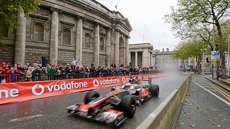 3 June 2012; Formula 1 driver Jenson Button competeing in his McLaren Mercedes F1 car, as he rounds the Bank of Ireland, during the Bavaria City Racing Event. College Green, Dublin. Picture credit: Barry Cregg / SPORTSFILE