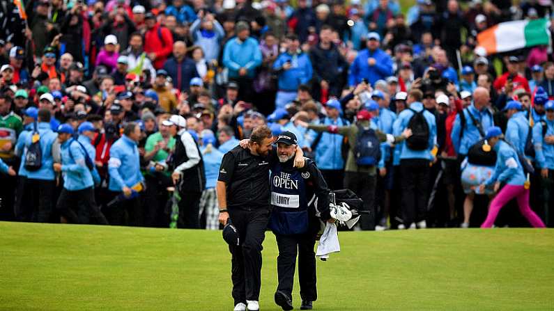 21 July 2019; Shane Lowry of Ireland celebrates with caddy Brian Martin as they walk onto the 18th green on their way to winning The Open Championship on Day Four of the 148th Open Championship at Royal Portrush in Portrush, Co Antrim. Photo by Brendan Moran/Sportsfile Photo by Brendan Moran/Sportsfile