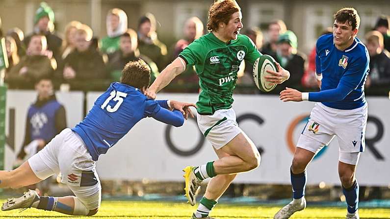 17 December 2022; Henry McErlean of Ireland evades the tackle of Tommaso Simoni of Italy, left, on his way to score his side's fourth try during the U20 Rugby International Friendly match between Ireland and Italy at Clontarf RFC in Dublin. Photo by Sam Barnes/Sportsfile