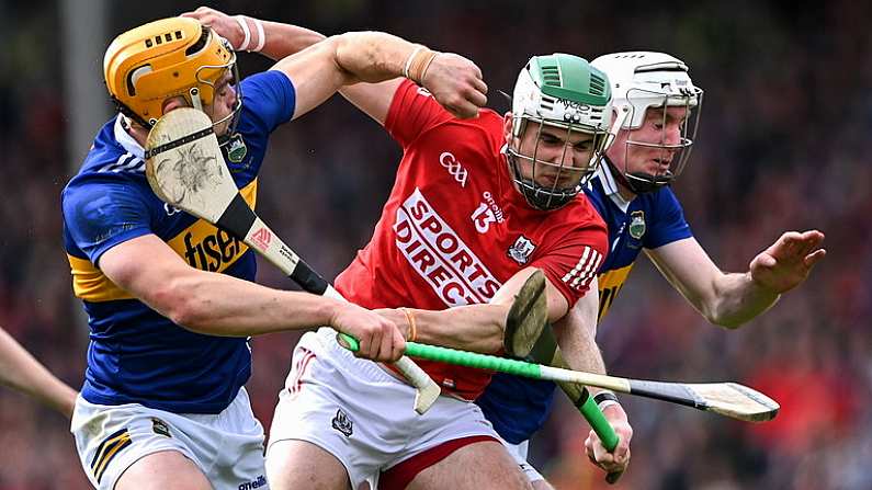 22 May 2022; Shane Kingston of Cork is tackled by Tipperary players Ronan Maher, left, and Seamus Kennedy during the Munster GAA Hurling Senior Championship Round 5 match between Tipperary and Cork at FBD Semple Stadium in Thurles, Tipperary. Photo by Piaras O Midheach/Sportsfile