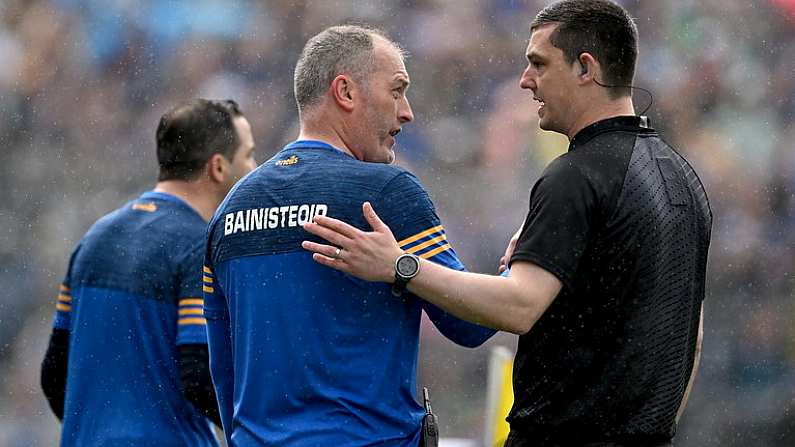 21 May 2023; Tipperary manager Liam Cahill is asked to leave the pitch by sideline official Ciaran O'Regan after being shown a red card by referee Sean Stack, not pictured, during the Munster GAA Hurling Senior Championship Round 4 match between Tipperary and Limerick at FBD Semple Stadium in Thurles, Tipperary. Photo by Brendan Moran/Sportsfile