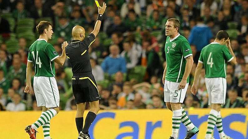 7 September 2010; Referee Leontios Trattlu, shows a yellow card to Richard Dunne, Republic of Ireland, during the second half. EURO 2012 Championship Qualifier - Group B, Republic of Ireland v Andorra, Aviva Stadium, Lansdowne Road, Dublin. Picture credit: David Maher / SPORTSFILE