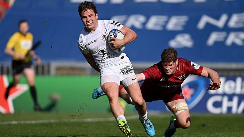 3 April 2021; Antoine Dupont of Toulouse on his way to scoring his side's third try despite the efforts of Jack O'Donoghue of Munster during the Heineken Champions Cup Round of 16 match between Munster and Toulouse at Thomond Park in Limerick. Photo by Ramsey Cardy/Sportsfile