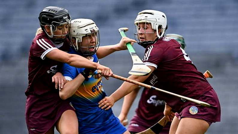 29 August 2021; Nicole Walsh of Tipperary is tackled by Niamh Kilkenny, left, and Dervla Higgins of Galway during the All-Ireland Senior Camogie Championship Semi-Final match between Tipperary and Galway at Croke Park in Dublin. Photo by Piaras O Midheach/Sportsfile