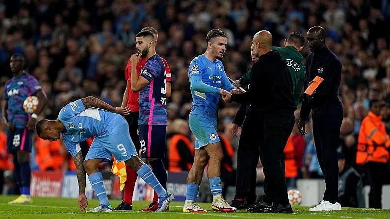 Jack Grealish (centre) shakes hands with manager Pep Guardiola,  PA Wire/PA Images