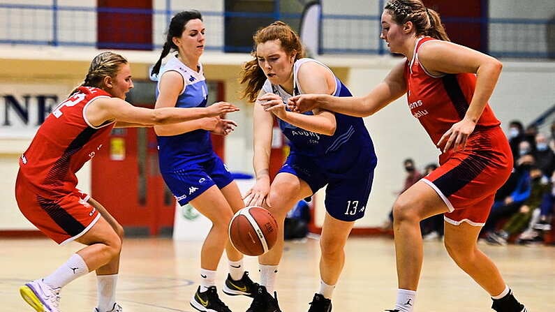 7 January 2022; Claire Melia of The Address UCC Glanmire in action against Simone O'Shea, left, and Shannon Ryan of Singleton Supervalu Brunell during the InsureMyHouse.ie Paudie OConnor Cup semi-final match between The Address UCC Glanmire and Singleton's SuperValu Brunell at Neptune Stadium in Cork. Photo by Sam Barnes/Sportsfile