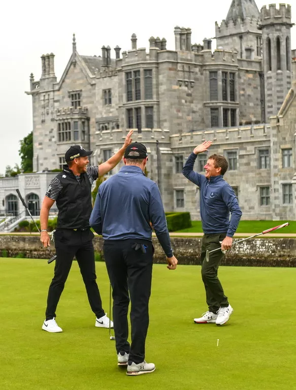 ormer jockey Johnny Murtagh celebrates an eagle putt on the 15th green with Danny Willett of England, left, during day two of the JP McManus Pro-Am at Adare Manor Golf Club