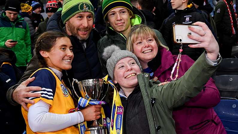 17 December 2022; Clonduff goalkeeper Katie McGilligan celebrates with her uncle's family, from left, her Uncle Thomas McGilligan and his wife Ciara and their children Orlaith, front, and Ruairi after her side's victory in the AIB All-Ireland Intermediate Camogie Club Championship Final match between Clonduff of Down and James Stephens of Kilkenny at Croke Park in Dublin. Photo by Piaras O Midheach/Sportsfile