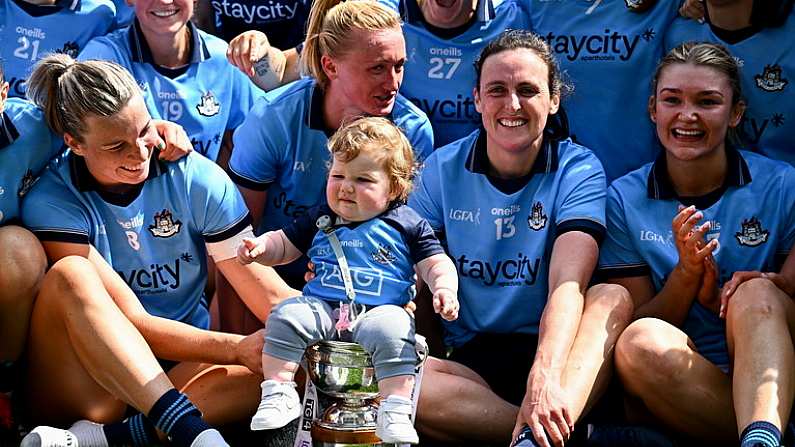 12 May 2024; Dublin players including Carla Rowe and Hannah Tyrrell, with her daughter Aoife, celebrate with the Mary Ramsbottom Cup after their side's victory in the Leinster LGFA Senior Football Championship final match between Dublin and Meath at Croke Park in Dublin. Photo by Harry Murphy/Sportsfile