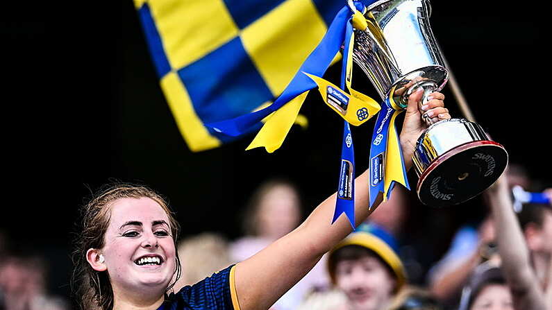 11 August 2024; Tipperary captain Sinead Meagher lifts the Kathleen Mills cup after her side's victory in the All-Ireland Premier Junior Camogie Championship final between Laois and Tipperary at Croke Park in Dublin. Photo by Piaras O Midheach/Sportsfile