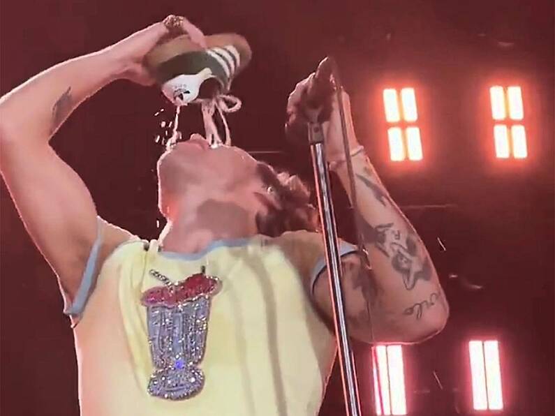 Harry Styles drinks out of his own shoe at Australian show