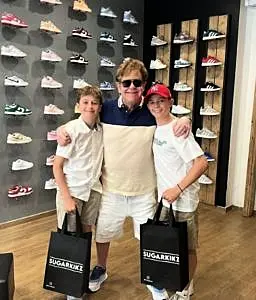 Elton John shopping with two sons