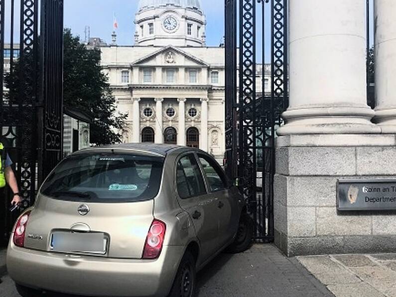 Woman arrested after car crashes into gates of Government Buildings