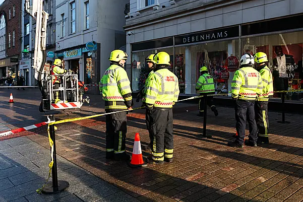 Section of busy shopping street in Cork closed off as chunk of concrete falls from building