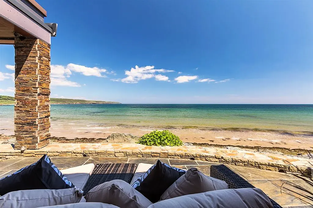 Pool at eye level with the ocean is this Irish coastal home's claim to fame