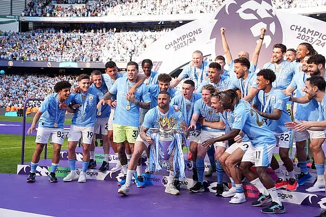 Manchester City players celebrate after winning the 2023-24 Premier League title last month - their fourth season in a row as top-flight champions