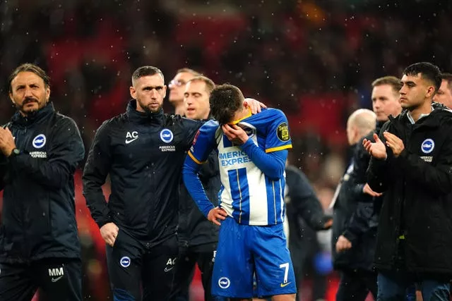 Solly March, centre, is consoled after missing his penalty in the shoot-out