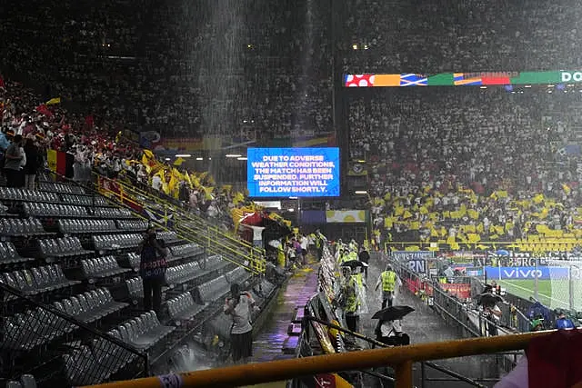 A message on a big screen at the stadium tells fans the match has been suspended