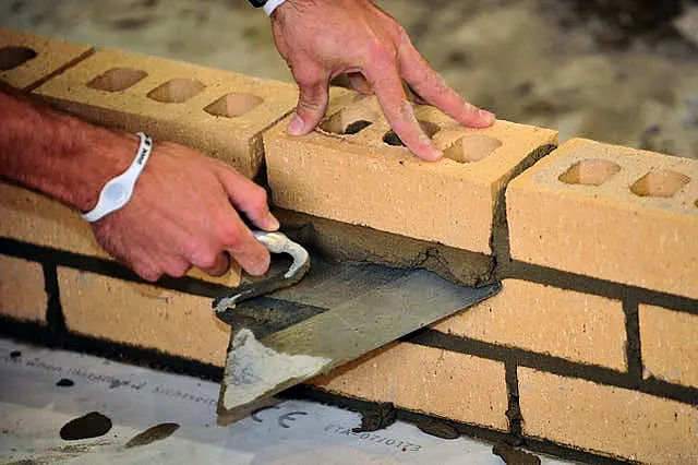 A bricklayer at work (Ian Nicholson/PA)