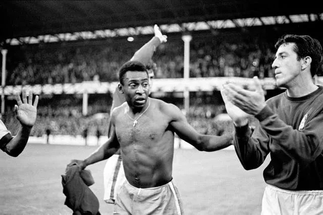 Pele, pictured with Portugal's Jose Augusto, swaps shirts after Brazil's early exit from the 1966 World Cup. The defending champions were eliminated at the end of the group stage following a 3-1 loss defeat to the Eusebio-inspired Portuguese at Goodison Park