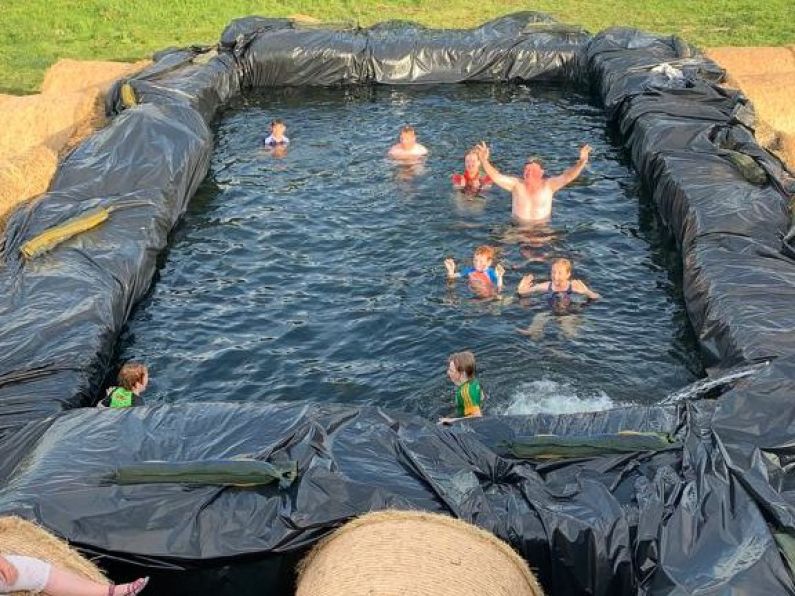Farmer builds makeshift swimming pool with bales of hay