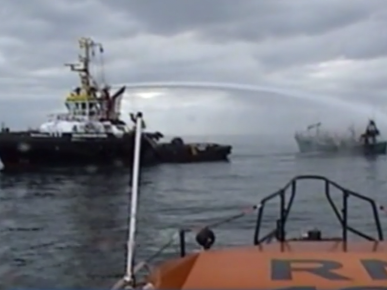 Three men rescued after trawler catches fire