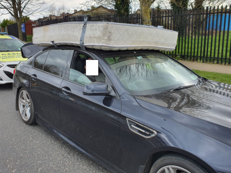Gardaí stop BMW driver after spotting mattress TAPED to car roof