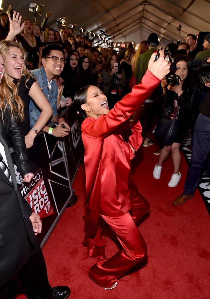 TV personality Karrueche Tran (C) takes a selfie with fans at the 2017 iHeartRadio Music Awards which broadcast live on Turner's TBS, TNT, and truTV at The Forum on March 5, 2017 in Inglewood, California.  (Photo by Frazer Harrison/Getty Images for iHeartMedia)