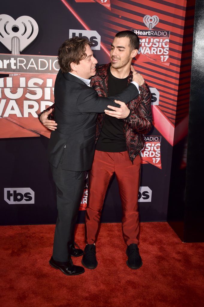 President of Republic Records Group Charlie Walk (L) and singer Joe Jonas of music group DNCE attends the 2017 iHeartRadio Music Awards which broadcast live on Turner's TBS, TNT, and truTV at The Forum on March 5, 2017 in Inglewood, California.  (Photo by Alberto E. Rodriguez/Getty Images)