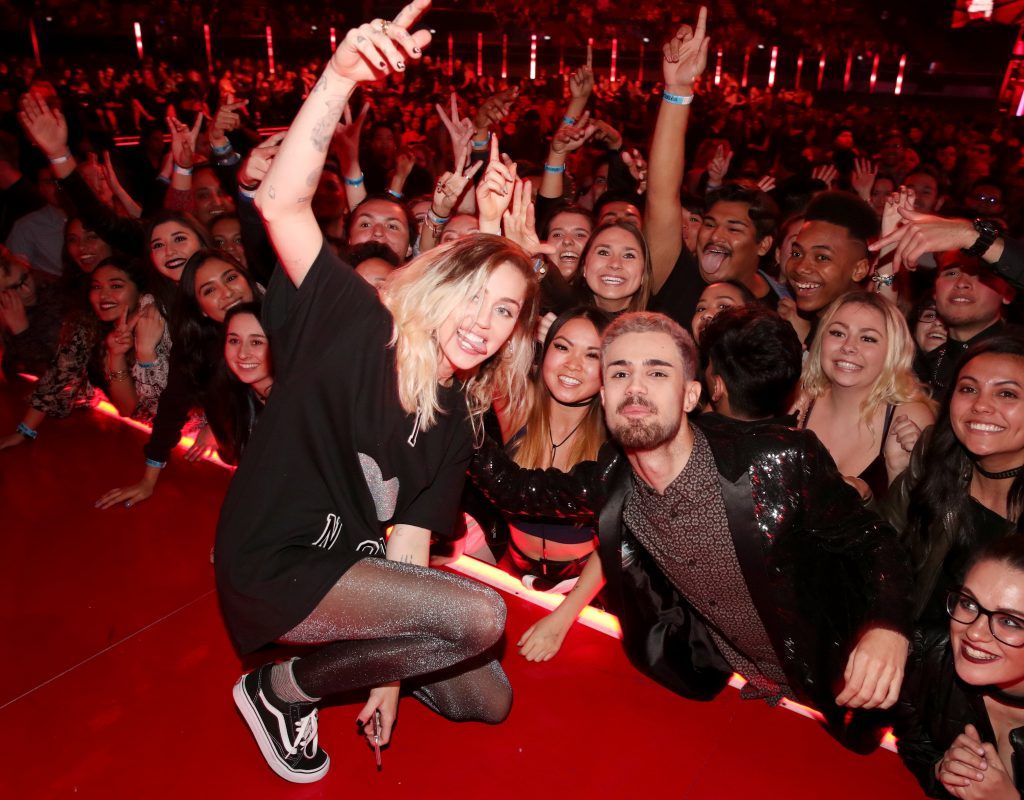 Singer-songwriter Miley Cyrus poses onstage with fans at the 2017 iHeartRadio Music Awards which broadcast live on Turner's TBS, TNT, and truTV at The Forum on March 5, 2017 in Inglewood, California.  (Photo by Christopher Polk/Getty Images for iHeartMedia)