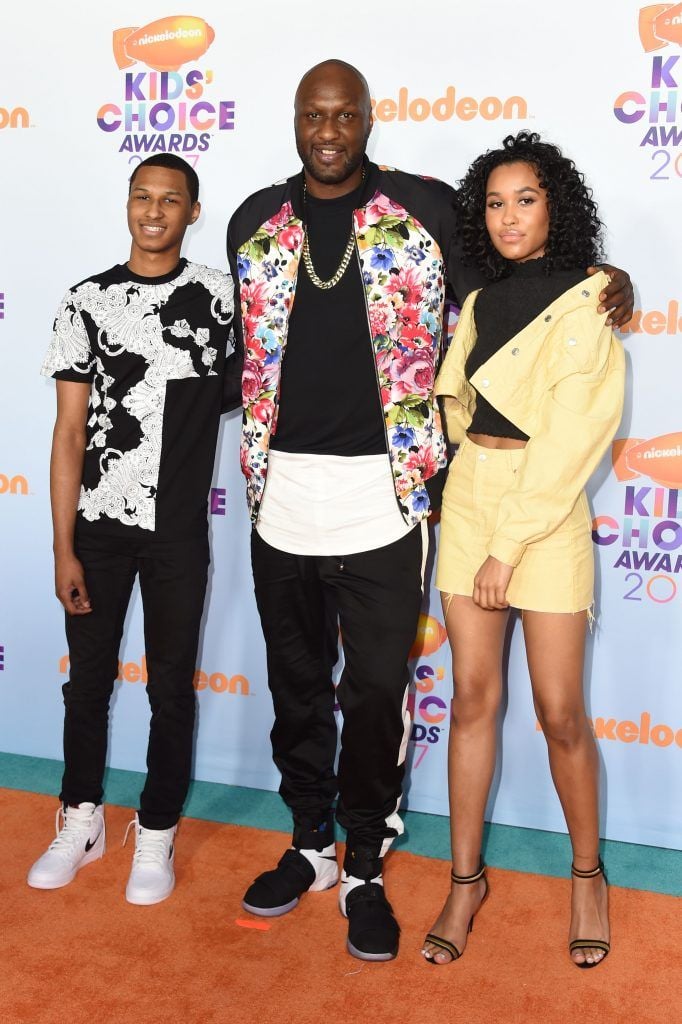 Former NBA basketball player Lamar Odom (C) arrives with guests for the 30th Annual Nickelodeon Kids' Choice Awards, March 11, 2017, at the Galen Center on the University of Southern California campus in Los Angeles. (Photo by VALERIE MACON/AFP/Getty Images)