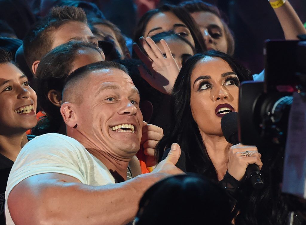 John Cena and Nikki Bella on stage at the 30th Annual Nickelodeon Kids' Choice Awards, March 11, 2017, at the Galen Center on the University of Southern California campus in Los Angeles.   (Photo by VALERIE MACON/AFP/Getty Images)
