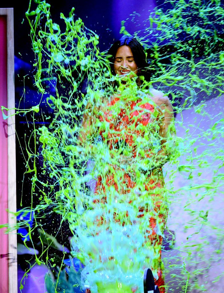 Singer-songwriter Demi Lovato gets slimed onstage at Nickelodeon's 2017 Kids' Choice Awards at USC Galen Center on March 11, 2017 in Los Angeles, California.  (Photo by Kevin Winter/Getty Images)