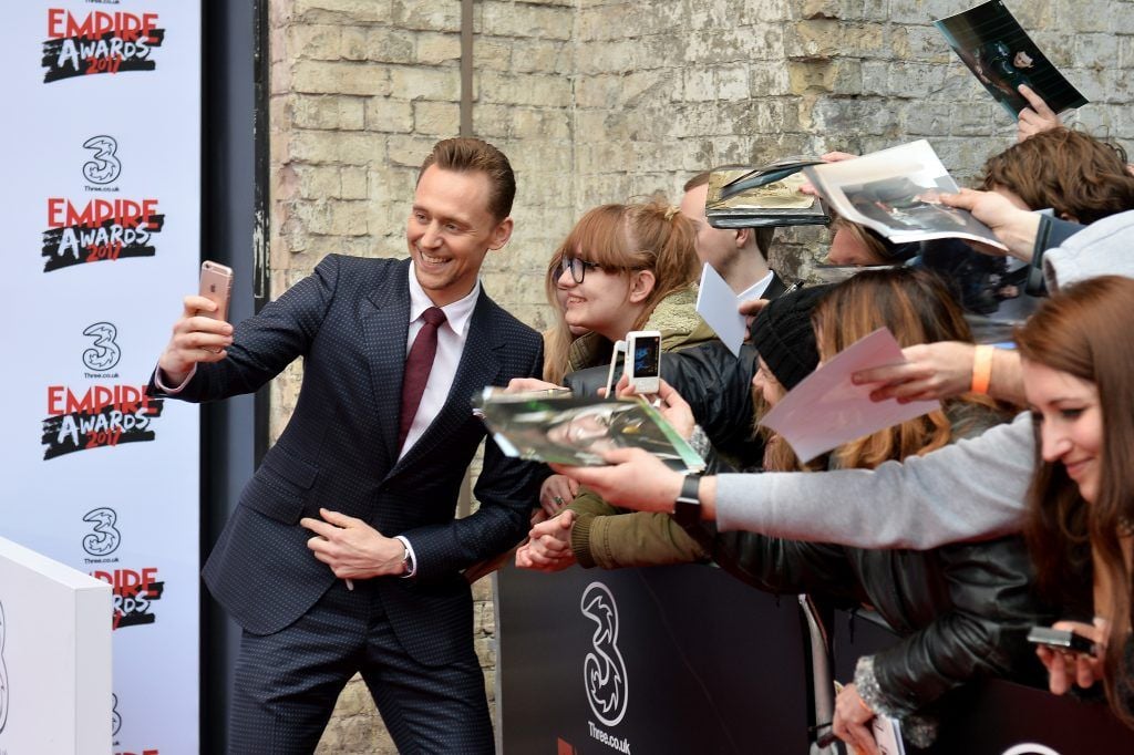 Actor Tom Hiddleston takes a selfie with a fan attends the THREE Empire awards at The Roundhouse on March 19, 2017 in London, England.  (Photo by Jeff Spicer/Getty Images)