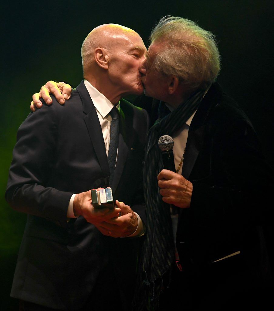 Sir Ian McKellen (R) kisses Sir Patrick Stewart (L) as he presents the award for Empire Legend to Stewart during the THREE Empire awards at The Roundhouse on March 19, 2017 in London, England.  (Photo by Ian Gavan/Getty Images)