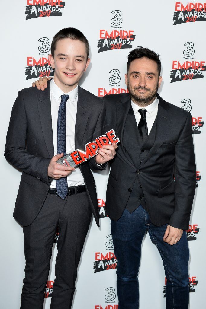 Actor Lewis MacDougall (L) and director Juan Antonio Bayona (R) pose with the Best Sci-fi/Fantasy award for the movie 'A Monster Calls' in the winners room at the THREE Empire awards at The Roundhouse on March 19, 2017 in London, England.  (Photo by Jeff Spicer/Getty Images)