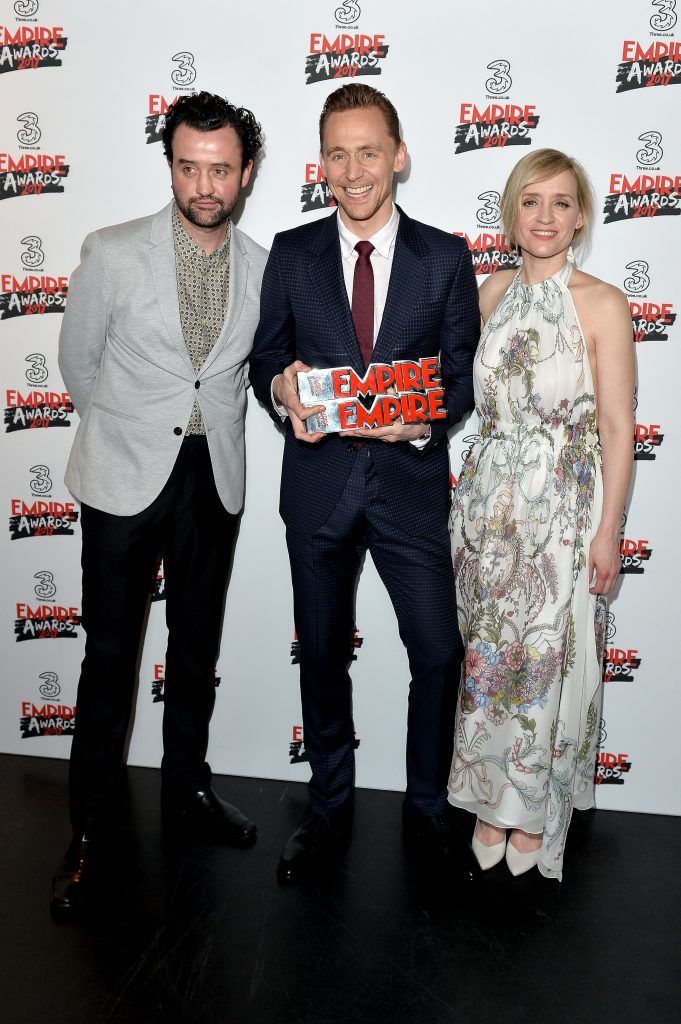 Tom Hiddleston (C) poses in the winners room with his two awards for Empire Hero and Best TV Series for The Night Manager with presenters Anne-Marie Duff (R) and Daniel Mays (L) at the THREE Empire awards at The Roundhouse on March 19, 2017 in London, England.  (Photo by Jeff Spicer/Getty Images)