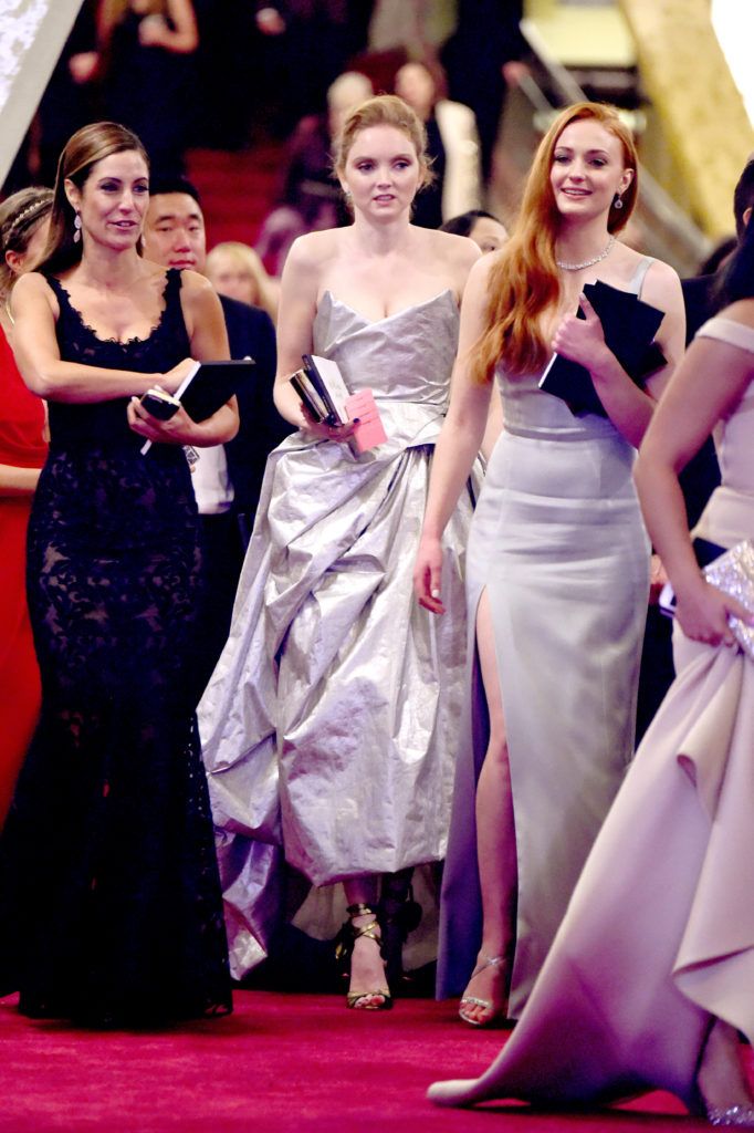Lily Cole (C) and Sophie Turner (R) depart the 88th Annual Academy Awards at Hollywood & Highland Center on February 28, 2016 in Hollywood, California.  (Photo by Frazer Harrison/Getty Images)
