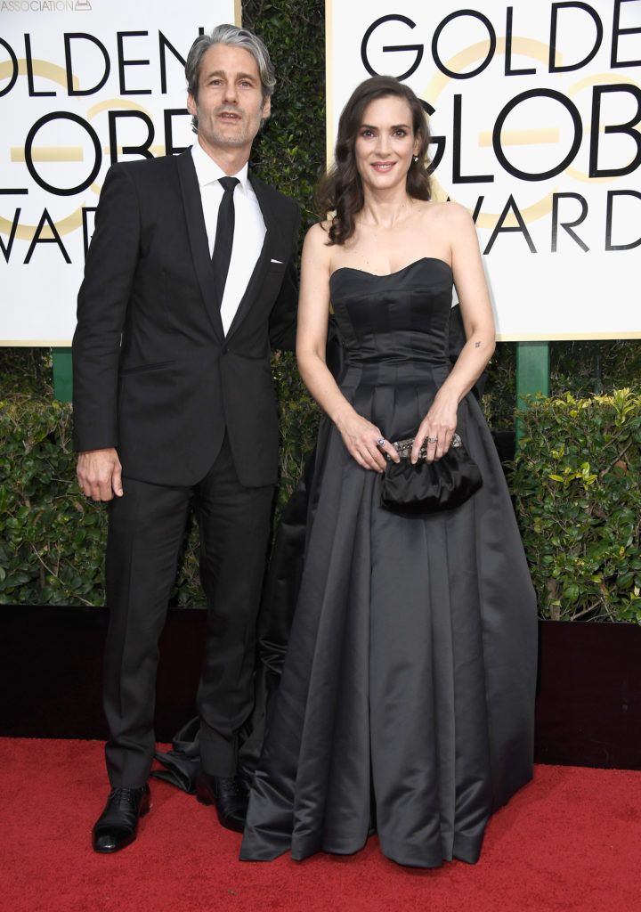 BEVERLY HILLS, CA - JANUARY 08:  Actress Winona Ryder (R) and Scott Mackinlay Hahn attend the 74th Annual Golden Globe Awards at The Beverly Hilton Hotel on January 8, 2017 in Beverly Hills, California.  (Photo by Frazer Harrison/Getty Images)