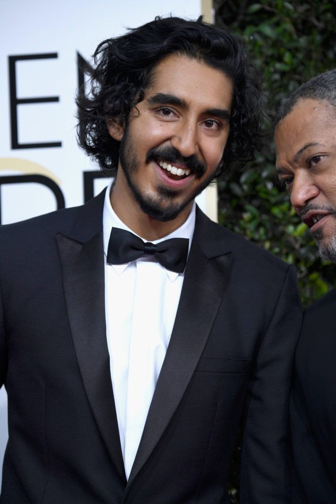 BEVERLY HILLS, CA - JANUARY 08: Actors Dev Patel and Laurence Fishburne attend the 74th Annual Golden Globe Awards at The Beverly Hilton Hotel on January 8, 2017 in Beverly Hills, California.  (Photo by Frazer Harrison/Getty Images)
