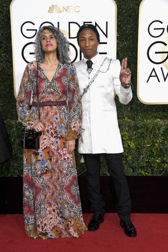 BEVERLY HILLS, CA - JANUARY 08:  Musician Pharrell Williams (R) and Helen Lasichanh attend the 74th Annual Golden Globe Awards at The Beverly Hilton Hotel on January 8, 2017 in Beverly Hills, California.  (Photo by Frazer Harrison/Getty Images)